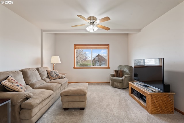living room with carpet floors, baseboards, and ceiling fan