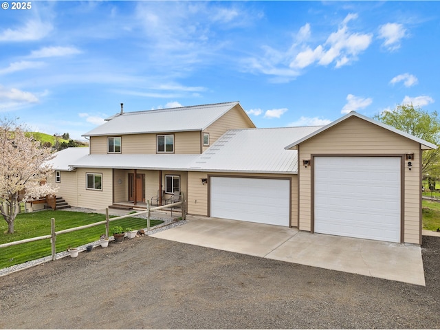 view of front of home with dirt driveway, covered porch, metal roof, a front lawn, and an attached garage