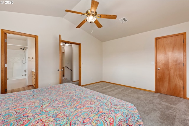 bedroom featuring carpet, connected bathroom, vaulted ceiling, visible vents, and baseboards