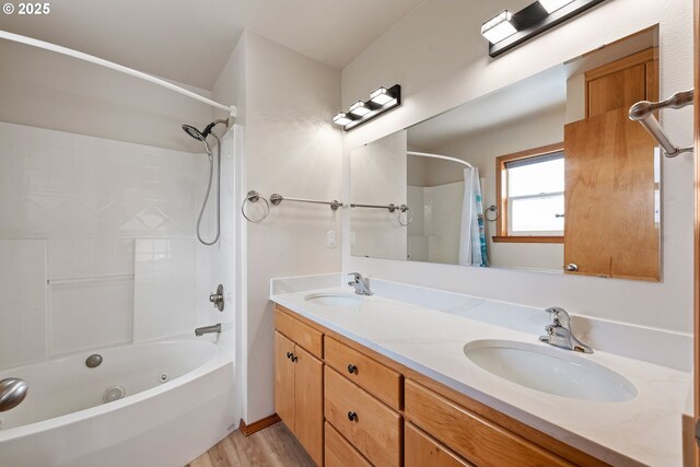 bathroom featuring a sink, double vanity, wood finished floors, and shower / bath combo