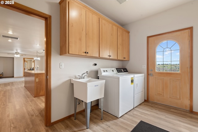 laundry area with cabinet space, a ceiling fan, visible vents, light wood finished floors, and washing machine and dryer