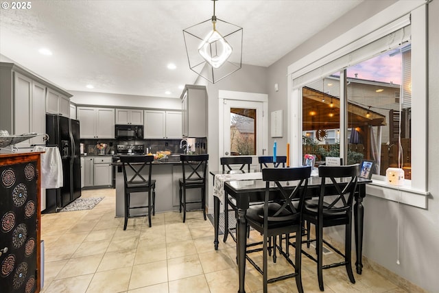 dining space with sink and light tile patterned floors