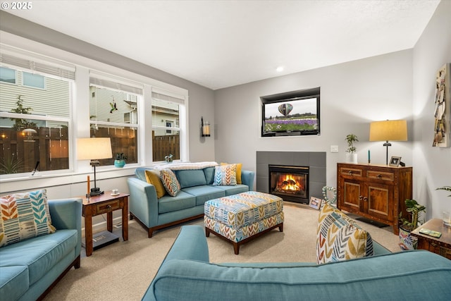 living room featuring light carpet and a fireplace