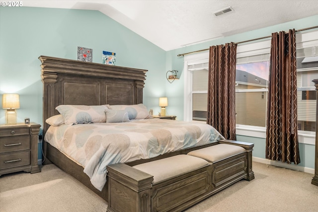 bedroom featuring light colored carpet and lofted ceiling