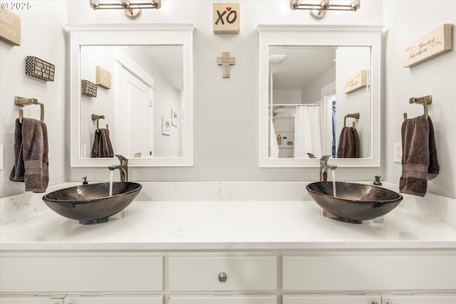 bathroom with curtained shower and vanity