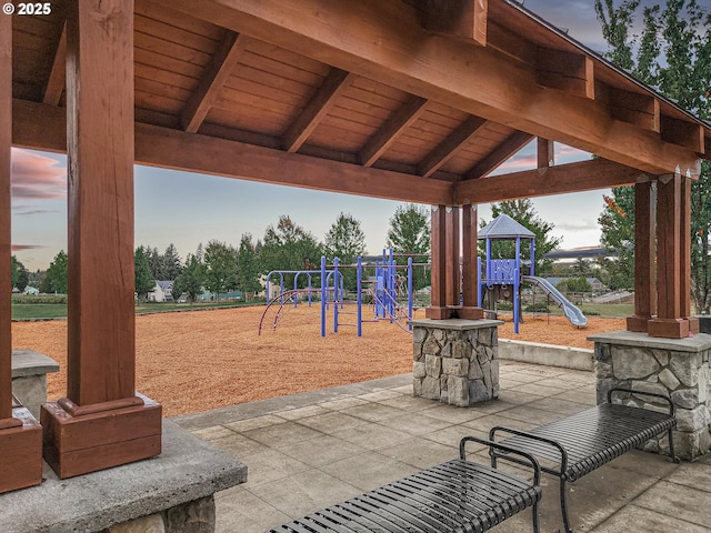 patio terrace at dusk with a playground and a gazebo