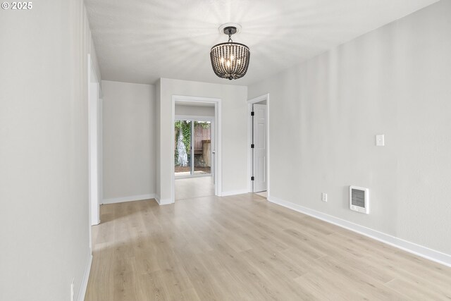 1061 NE Avery St, Newport, OR 97365 - empty room featuring a chandelier, light wood finished floors, and baseboards