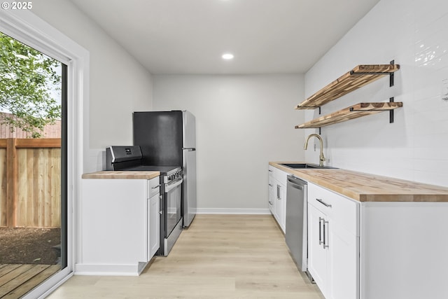 1061 NE Avery St, Newport, OR 97365 - kitchen featuring range with electric cooktop, wooden counters, open shelves, a sink, and dishwasher