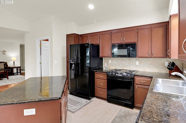 kitchen featuring a center island, a sink, dark stone countertops, decorative backsplash, and black appliances