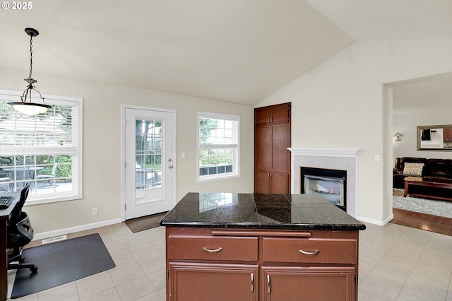 kitchen featuring decorative light fixtures, plenty of natural light, lofted ceiling, and light tile patterned floors
