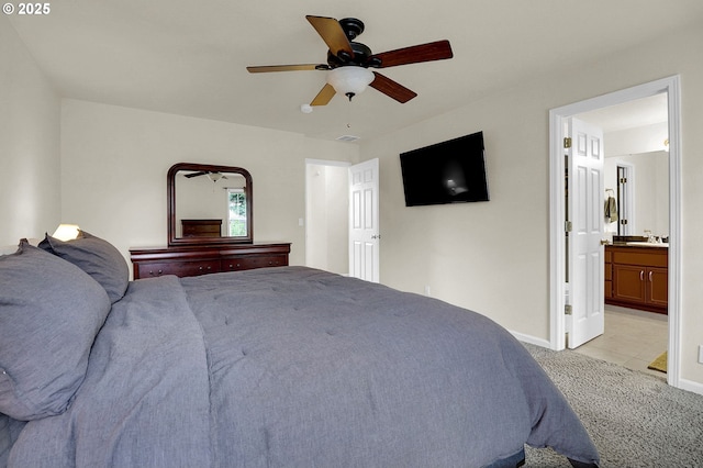 bedroom with visible vents, a ceiling fan, baseboards, light colored carpet, and ensuite bathroom