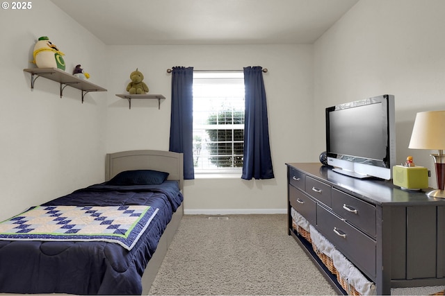 bedroom with baseboards and light carpet