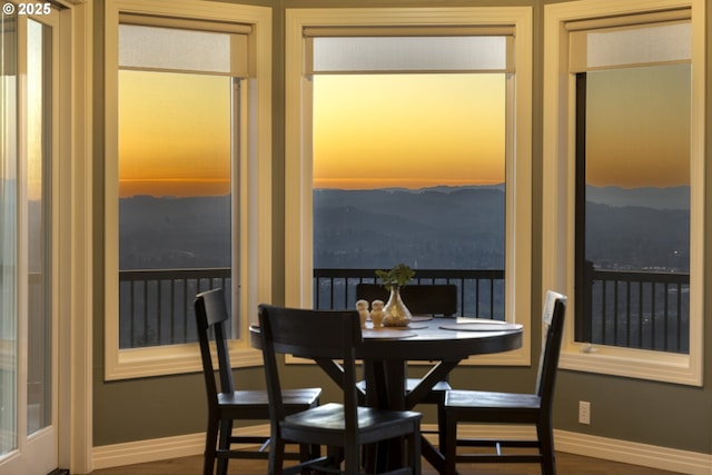 dining space with wood-type flooring and a mountain view