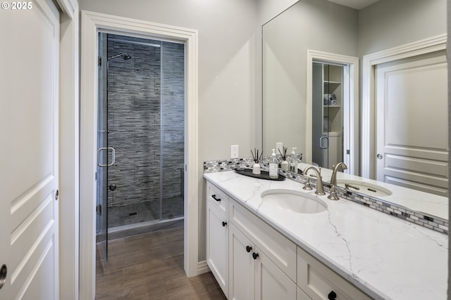 bathroom featuring vanity and an enclosed shower