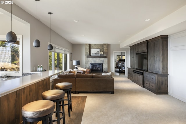 living room featuring light carpet and a large fireplace