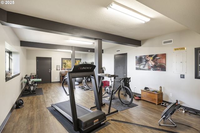 exercise room with wood-type flooring