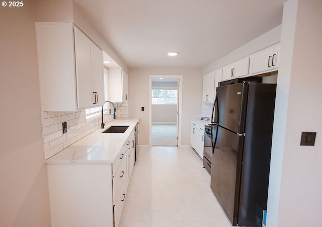 2797 Tulip St, Eugene, OR 97408 - kitchen featuring freestanding refrigerator, a sink, backsplash, light countertops, and white cabinets