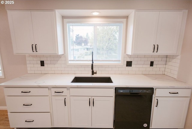 2797 Tulip St, Eugene, OR 97408 - kitchen with black dishwasher, a sink, white cabinets, and light stone counters