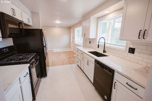 2797 Tulip St, Eugene, OR 97408 - kitchen featuring black appliances, a sink, baseboards, backsplash, and white cabinets