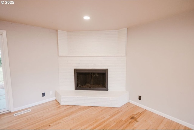 2797 Tulip St, Eugene, OR 97408 - unfurnished living room with baseboards, wood finished floors, recessed lighting, and a brick fireplace