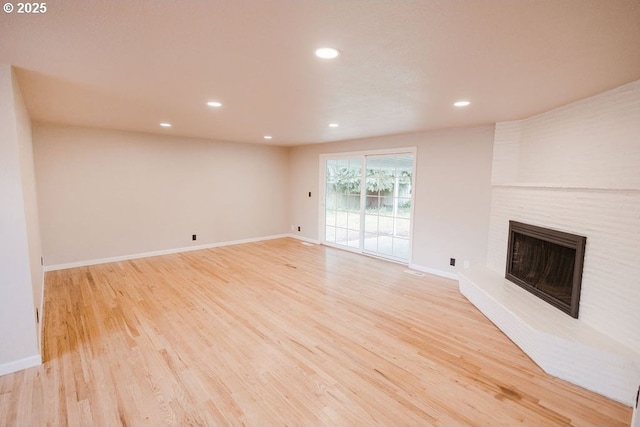 2797 Tulip St, Eugene, OR 97408 - unfurnished living room with light wood finished floors, a fireplace, recessed lighting, and baseboards
