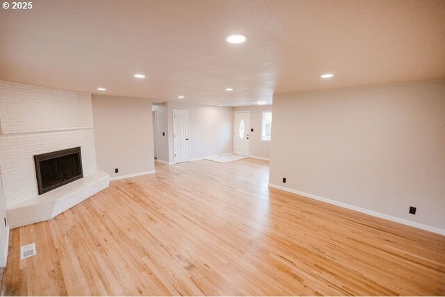 2797 Tulip St, Eugene, OR 97408 - unfurnished living room with recessed lighting, light wood-style flooring, a fireplace, and baseboards