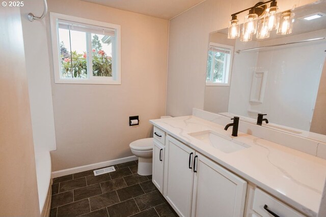 2797 Tulip St, Eugene, OR 97408 - bathroom with baseboards, toilet, and vanity
