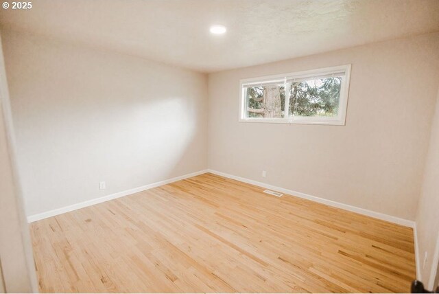 2797 Tulip St, Eugene, OR 97408 - unfurnished room with wood finished floors, baseboards, and recessed lighting