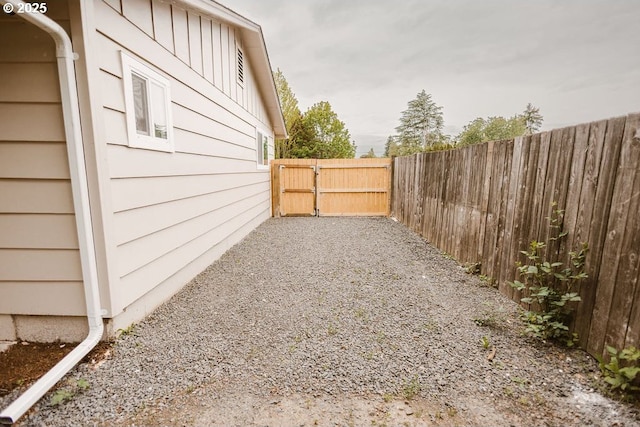 2797 Tulip St, Eugene, OR 97408 - view of side of home featuring fence, a gate, and board and batten siding