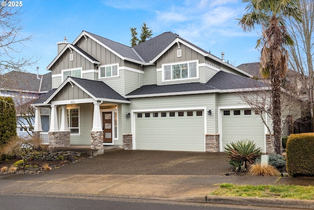 craftsman house featuring driveway, stone siding, a porch, roof with shingles, and board and batten siding