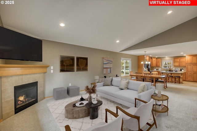 living room with baseboards, a tiled fireplace, light colored carpet, lofted ceiling, and recessed lighting