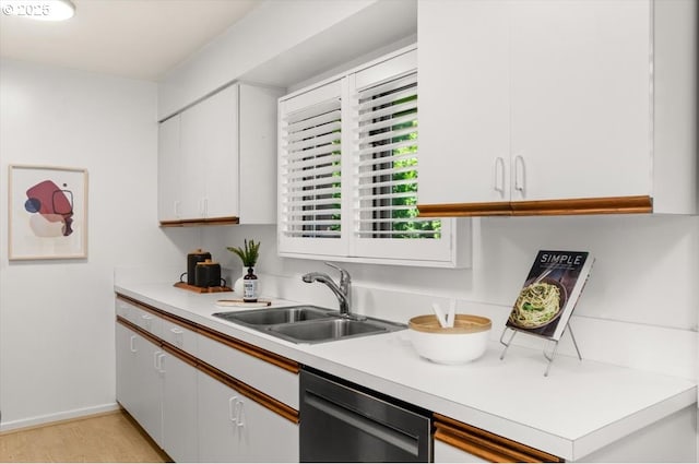 2425 SW 19th Ave Unit 9, Portland, OR 97201 - kitchen with dishwasher, light countertops, light wood finished floors, and white cabinetry