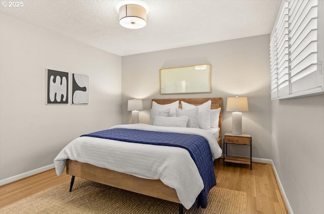 2425 SW 19th Ave Unit 9, Portland, OR 97201 - bedroom with wood finished floors and a textured ceiling