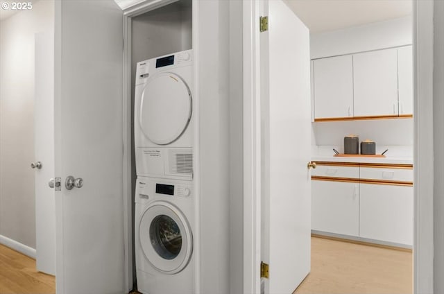 2425 SW 19th Ave Unit 9, Portland, OR 97201 - laundry area featuring stacked washer and clothes dryer and light wood-type flooring