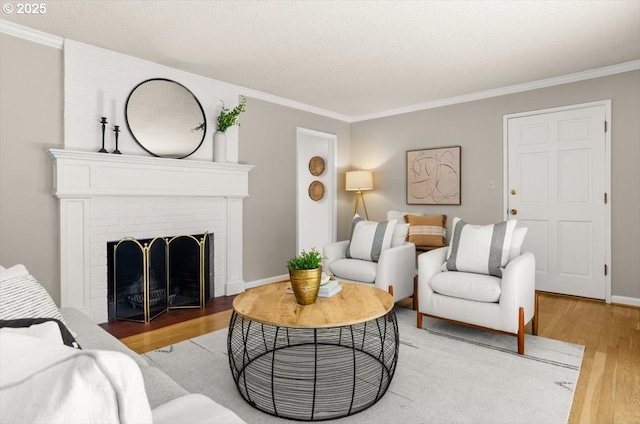 2425 SW 19th Ave Unit 9, Portland, OR 97201 - living room featuring light wood finished floors, ornamental molding, and a brick fireplace