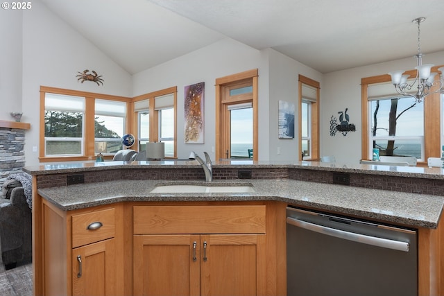 45 NW Harney St, Depoe Bay, OR 97341 - kitchen featuring stainless steel dishwasher, dark stone countertops, hanging light fixtures, a chandelier, and vaulted ceiling