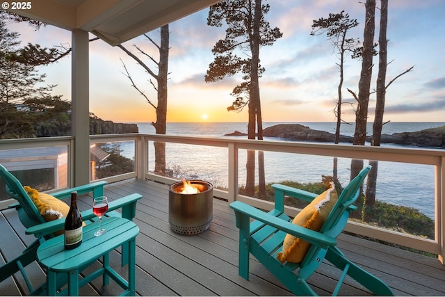 45 NW Harney St, Depoe Bay, OR 97341 - deck at dusk with a water view and an outdoor fire pit