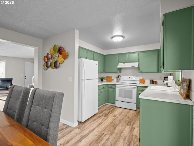 kitchen with sink, green cabinets, white appliances, light hardwood / wood-style floors, and a textured ceiling