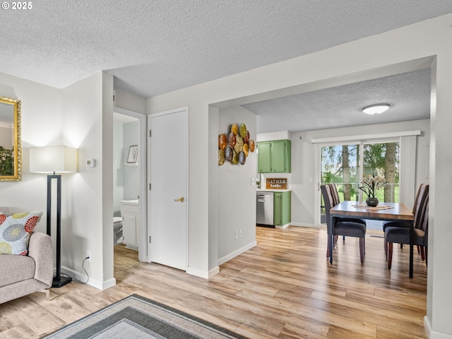 interior space with a textured ceiling and light wood-type flooring