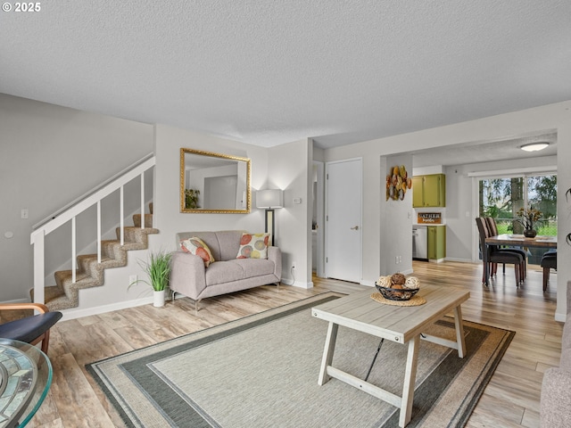 living room with wood-type flooring and a textured ceiling