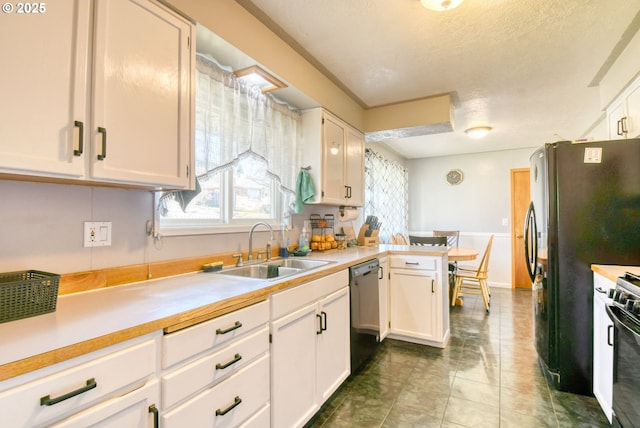 kitchen featuring dishwashing machine, white cabinets, a sink, and light countertops