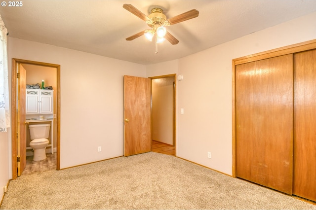 unfurnished bedroom with carpet floors, a ceiling fan, a closet, and ensuite bathroom