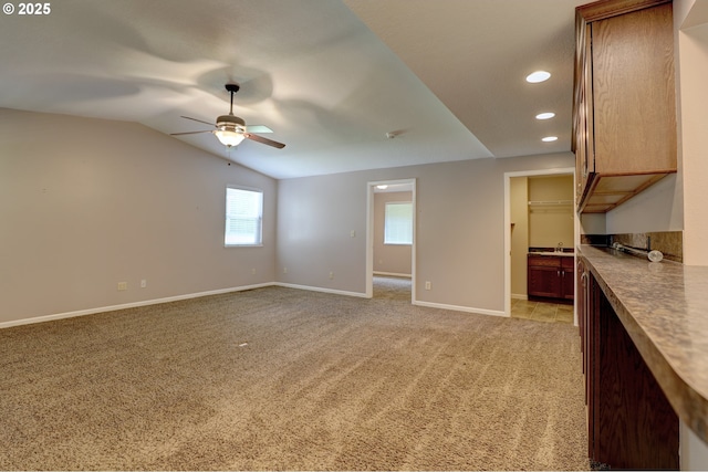 640 Sherman Dr, The Dalles, OR 97058 - unfurnished living room featuring a ceiling fan, recessed lighting, vaulted ceiling, light colored carpet, and baseboards
