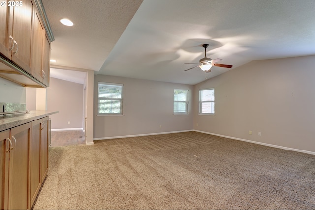 640 Sherman Dr, The Dalles, OR 97058 - unfurnished living room featuring lofted ceiling, ceiling fan, healthy amount of natural light, light carpet, and baseboards