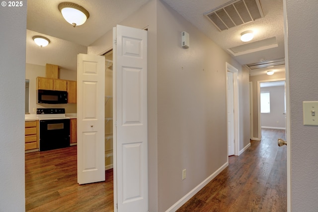 640 Sherman Dr, The Dalles, OR 97058 - hall featuring dark wood-style floors, baseboards, and a textured ceiling