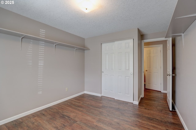 640 Sherman Dr, The Dalles, OR 97058 - unfurnished bedroom with dark wood-style flooring, a textured ceiling, a closet, and baseboards
