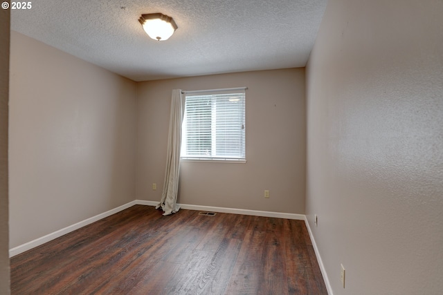 640 Sherman Dr, The Dalles, OR 97058 - unfurnished room featuring dark wood-style flooring, baseboards, and a textured ceiling