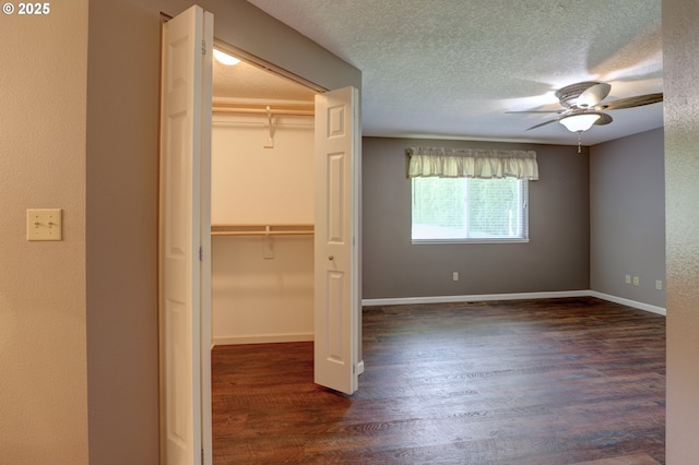 640 Sherman Dr, The Dalles, OR 97058 - unfurnished bedroom featuring dark wood-style flooring, a closet, a textured ceiling, ceiling fan, and baseboards