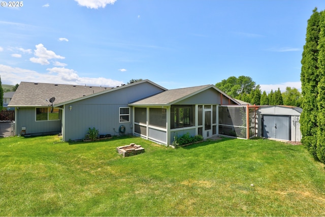 640 Sherman Dr, The Dalles, OR 97058 - back of house featuring a sunroom, an outdoor fire pit, a yard, and a shingled roof