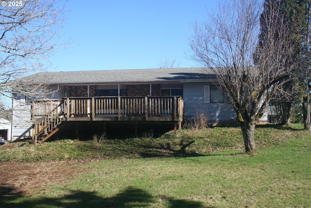 rear view of house with a yard and stairway